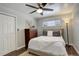 Bright bedroom with a comfortable bed, a dresser with plant and a ceiling fan at 306 S Newport Way, Denver, CO 80224