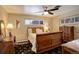 Bedroom features a sleigh bed, ceiling fan, neutral paint, and two windows for natural light at 306 S Newport Way, Denver, CO 80224
