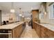 Spacious kitchen with stainless steel appliances, granite countertops, and a large island with pendant lighting at 306 S Newport Way, Denver, CO 80224
