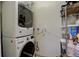 Efficient laundry room with stacked washer and dryer, maximizing space and convenience for laundry tasks at 306 S Newport Way, Denver, CO 80224