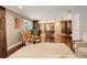 Cozy living room featuring hardwood floors, a comfortable chair, and an open layout leading to the kitchen at 306 S Newport Way, Denver, CO 80224