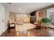Inviting living room with hardwood floors, a modern fireplace, a large sectional sofa, and natural lighting at 306 S Newport Way, Denver, CO 80224