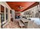 Inviting covered patio with a brick floor, stone fireplace, and outdoor seating for enjoyable entertaining at 306 S Newport Way, Denver, CO 80224