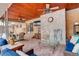 Cozy covered patio boasts a ceiling fan, rustic brick accents, and comfortable seating, perfect for outdoor relaxation at 306 S Newport Way, Denver, CO 80224