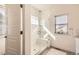 Contemporary bathroom with a glass-enclosed shower, window, and clean lines, offering a spa-like experience at 2572 Iola St, Aurora, CO 80010