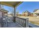 Relaxing front porch with a comfortable chair and a view of the quiet neighborhood street at 2572 Iola St, Aurora, CO 80010