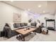 Spacious living room with a large gray sectional sofa, a rustic wood coffee table, and modern decor at 2572 Iola St, Aurora, CO 80010