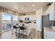 Modern kitchen with white cabinets, granite counters, and island at 42774 Calusa Pines Rd, Elizabeth, CO 80107