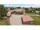 A birds eye view of home, outbuildings and expansive driveway at 11485 Pecos St, Denver, CO 80234