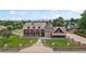 Grand home with an eye catching turret, mature landscaping, and a gated entrance at 11485 Pecos St, Denver, CO 80234