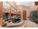 The main bath features a marble tub on raised platform, a shower, and a custom door, mirrors, and light fixtures at 11485 Pecos St, Denver, CO 80234