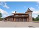 Stately home with brick and turret design, featuring an attached garage and upper balcony at 11485 Pecos St, Denver, CO 80234