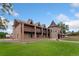 Expansive brick home with a distinctive turret and well-manicured lawn at 11485 Pecos St, Denver, CO 80234