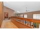 The upstairs hallway features a wood banister and offers a view of the lower level at 11485 Pecos St, Denver, CO 80234