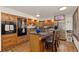 Charming kitchen with wood cabinets, an island cooktop, and stainless steel refrigerator at 11485 Pecos St, Denver, CO 80234