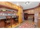 Charming kitchen with wood cabinets, breakfast bar, and tile flooring, perfect for cooking and entertaining at 11485 Pecos St, Denver, CO 80234