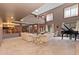 Large living room featuring a fireplace, grand piano, and high ceilings at 11485 Pecos St, Denver, CO 80234