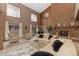Bright living room with a fireplace, grand piano, and backyard views at 11485 Pecos St, Denver, CO 80234