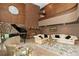 Spacious living room featuring a stone fireplace, piano, and large windows at 11485 Pecos St, Denver, CO 80234