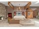 A creative main bedroom features custom wood accents, turret, and stone fireplace in a very large and open space at 11485 Pecos St, Denver, CO 80234