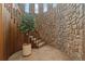 Unique interior staircase featuring stone walls, wood trim, and a decorative potted tree at 11485 Pecos St, Denver, CO 80234