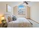 Cozy bedroom with a vaulted ceiling and large arched window at 2136 S Scranton Way, Aurora, CO 80014