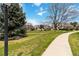 Community landscape with sidewalks, manicured lawns, mature trees, and inviting neighborhood buildings at 2136 S Scranton Way, Aurora, CO 80014
