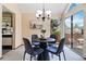 Charming dining area with backyard views and a modern chandelier at 2136 S Scranton Way, Aurora, CO 80014
