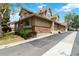 Townhouse exterior featuring a well-maintained lawn and a brick facade at 2136 S Scranton Way, Aurora, CO 80014