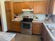 Well-maintained kitchen featuring stainless steel appliances, wood cabinets, and light countertops at 2136 S Scranton Way, Aurora, CO 80014