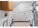Laundry room with linoleum floors and featuring a washer, dryer, water heater and storage cabinet at 2136 S Scranton Way, Aurora, CO 80014