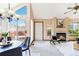 Sunlit living room with fireplace, large windows, and access to the patio for seamless indoor-outdoor living at 2136 S Scranton Way, Aurora, CO 80014