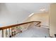 View of carpeted loft overlooking the living room with a skylight letting in plenty of natural light at 2136 S Scranton Way, Aurora, CO 80014