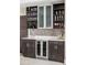 Stylish wet bar with custom cabinetry, beverage cooler, and mosaic tile backsplash at 3255 S Birch St, Denver, CO 80222