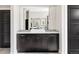 Stylish bathroom vanity with vessel sink, framed mirror, and dark wood cabinets at 3255 S Birch St, Denver, CO 80222