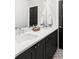 Bathroom featuring double sinks, dark cabinets and quartz countertops at 3255 S Birch St, Denver, CO 80222