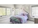 Bright bedroom with three windows, a plush bed, and charming decor at 3255 S Birch St, Denver, CO 80222