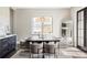 Bright dining room features a sleek table, modern chandelier, and large window at 3255 S Birch St, Denver, CO 80222