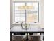 A modern chandelier hangs over the dining table, lit by a large window at 3255 S Birch St, Denver, CO 80222