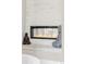 Modern fireplace with stone surround and meditating Buddha statues on the mantel at 3255 S Birch St, Denver, CO 80222