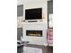 Modern fireplace with white stone surround and decorative mantle. Black framed TV mounted above at 3255 S Birch St, Denver, CO 80222