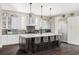 Bright kitchen with a large island, stainless steel appliances, pendant lighting, and sleek cabinetry at 3255 S Birch St, Denver, CO 80222