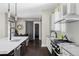 Modern kitchen with stainless steel appliances, a large island, and access to the dining area at 3255 S Birch St, Denver, CO 80222