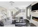 Spacious living room with hardwood floors, fireplace, modern staircase, and sophisticated decor at 3255 S Birch St, Denver, CO 80222