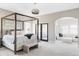 Spacious main bedroom with a canopy bed, sitting area, and natural light at 3255 S Birch St, Denver, CO 80222
