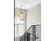 Staircase with a modern light fixture, large window, and contemporary railings at 3255 S Birch St, Denver, CO 80222