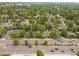 Aerial view of homes, trees, and a thoroughfare in a suburban neighborhood at 25 S Wadsworth Blvd, Lakewood, CO 80226