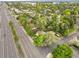 Aerial view looking over mature trees to a property adjacent to a thoroughfare at 25 S Wadsworth Blvd, Lakewood, CO 80226