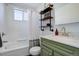 Cozy bathroom featuring a bathtub, shower, and a sink with modern vanity, decorated with matching colors at 1140 N Downing St # 303, Denver, CO 80218