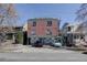 Three-story brick building with parking underneath, staircase, and possible rooftop deck at 1140 N Downing St # 303, Denver, CO 80218